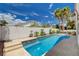 Enjoy outdoor living with this sparkling pool, set in a lush backyard with palm trees and desert landscaping at 4334 Libbiano Ct, Las Vegas, NV 89141