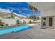 Inviting outdoor pool with a spa, showcasing palm trees and a serene backyard setting at 4334 Libbiano Ct, Las Vegas, NV 89141