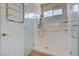 Shower with frameless glass doors, grab bars, a hand-held shower, and a tiled floor at 4334 Libbiano Ct, Las Vegas, NV 89141