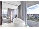 Modern bathroom with soaking tub and city view through large windows with access to balcony at 4381 W Flamingo Rd # 1102/1104, Las Vegas, NV 89103
