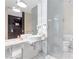 Contemporary bathroom with vessel sinks, marble countertop, and glass-enclosed toilet area at 4381 W Flamingo Rd # 1102/1104, Las Vegas, NV 89103