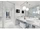 Luxurious bathroom showcasing dual sinks, marble walls, and a glass-enclosed shower at 4381 W Flamingo Rd # 1102/1104, Las Vegas, NV 89103