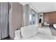 Luxurious bathroom features a standalone tub with stylish fixtures and serene city views at 4381 W Flamingo Rd # 1102/1104, Las Vegas, NV 89103