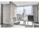 Chic seating area with city views seen through large windows, enhanced by modern furnishings at 4381 W Flamingo Rd # 1102/1104, Las Vegas, NV 89103