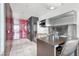 Modern kitchen featuring stainless steel appliances, sleek cabinetry, and an adjacent dining area at 4381 W Flamingo Rd # 1102/1104, Las Vegas, NV 89103