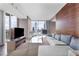 Bright living room with comfortable seating, TV, and stunning city views through expansive windows at 4381 W Flamingo Rd # 1102/1104, Las Vegas, NV 89103