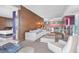 Open-concept living area with contemporary furniture, wood accents, and a glimpse into the bedroom at 4381 W Flamingo Rd # 1102/1104, Las Vegas, NV 89103