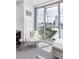 Bright living room featuring a modern chair, city views through large windows, and contemporary design elements at 4381 W Flamingo Rd # 1102/1104, Las Vegas, NV 89103