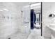 Elegant marble shower features dual shower heads, sleek fixtures, and glass door at 4381 W Flamingo Rd # 1102/1104, Las Vegas, NV 89103