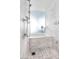 Elegant shower area with marble tile, rainfall showerhead, and glass enclosure at 4381 W Flamingo Rd # 1102/1104, Las Vegas, NV 89103