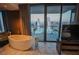Bathroom featuring a large soaking tub, views of the cityscape, and modern finishes at 4381 W Flamingo Rd # 2302, Las Vegas, NV 89103