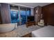 Modern bedroom with a soaking tub and floor-to-ceiling windows overlooking city views at 4381 W Flamingo Rd # 2302, Las Vegas, NV 89103
