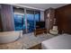 Bedroom with a luxurious soaking tub, city views, and modern design elements at 4381 W Flamingo Rd # 2302, Las Vegas, NV 89103