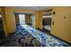 Hallway view with elevator access, neutral color scheme, and patterned carpeting leading to a window at 4381 W Flamingo Rd # 2302, Las Vegas, NV 89103