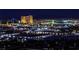 Night cityscape with illuminated buildings and mountain backdrop, viewed from an elevated position at 4381 W Flamingo Rd # 2302, Las Vegas, NV 89103