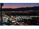 Stunning city night view with illuminated buildings and mountain backdrop at 4381 W Flamingo Rd # 2302, Las Vegas, NV 89103