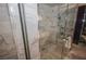 Modern bathroom featuring a glass-enclosed shower with marble tile at 4381 W Flamingo Rd # 2302, Las Vegas, NV 89103