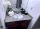 Bathroom featuring granite countertops, a sink, vanity and decorative flowers at 4965 Indian River Dr # 101, Las Vegas, NV 89103