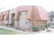 An exterior view showcasing a two-story condo with a tiled roof and stone facade at 4965 Indian River Dr # 101, Las Vegas, NV 89103