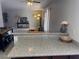 Open-concept kitchen with dark wood cabinets, modern appliances, and breakfast bar at 4965 Indian River Dr # 101, Las Vegas, NV 89103