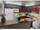 Well-equipped kitchen featuring dark cabinetry, white appliances, and ample counter space at 4965 Indian River Dr # 101, Las Vegas, NV 89103