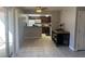 Open-concept kitchen with dark wood cabinets, modern appliances, and breakfast bar at 4965 Indian River Dr # 101, Las Vegas, NV 89103