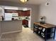Open-concept kitchen with dark wood cabinets, modern appliances, and breakfast bar at 4965 Indian River Dr # 101, Las Vegas, NV 89103