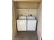 Laundry closet features a white washer, dryer, and shelf space for storage at 4965 Indian River Dr # 101, Las Vegas, NV 89103