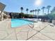 Community pool with palm trees and surrounding sun deck area at 4965 Indian River Dr # 101, Las Vegas, NV 89103