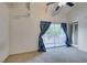 This bedroom features vaulted ceiling, a ceiling fan, with balcony access, and neutral carpet at 516 Delfern Ln, Las Vegas, NV 89169
