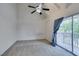 This bedroom features vaulted ceiling, a ceiling fan, with balcony access, and neutral carpet at 516 Delfern Ln, Las Vegas, NV 89169