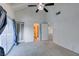 This bedroom features vaulted ceiling, a ceiling fan, with an attached bathroom and balcony access at 516 Delfern Ln, Las Vegas, NV 89169