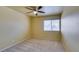 Bright bedroom features neutral walls, ceiling fan, and carpeted floors at 516 Delfern Ln, Las Vegas, NV 89169