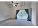 This bedroom features vaulted ceiling, a ceiling fan, with balcony access, and neutral carpet at 516 Delfern Ln, Las Vegas, NV 89169