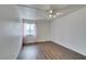 Minimalist bedroom with laminate wood floors, natural light, and simple decor at 516 Delfern Ln, Las Vegas, NV 89169