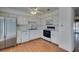 Well-lit kitchen equipped with white appliances and wood flooring at 516 Delfern Ln, Las Vegas, NV 89169