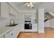 Bright kitchen featuring all-white appliances and wood-look flooring at 516 Delfern Ln, Las Vegas, NV 89169