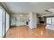Open floor plan with white kitchen, and vinyl flooring, leading to living area with fireplace at 516 Delfern Ln, Las Vegas, NV 89169