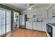 Bright kitchen features stainless steel refrigerator, white cabinets, and vinyl flooring at 516 Delfern Ln, Las Vegas, NV 89169