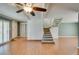 Warm living room with ceiling fan, wood floors, and stairs at 516 Delfern Ln, Las Vegas, NV 89169