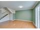 Bright living room featuring light, stairs, and light green accent wall at 516 Delfern Ln, Las Vegas, NV 89169