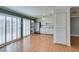 Open floor plan with wood floors, white kitchen cabinets, and stainless-steel refrigerator at 516 Delfern Ln, Las Vegas, NV 89169