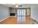 Open living area features wood floors, ceiling fan, and a cozy fireplace at 516 Delfern Ln, Las Vegas, NV 89169
