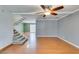 Spacious living room with ceiling fan, wood floors, and carpeted stairs at 516 Delfern Ln, Las Vegas, NV 89169