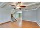 Comfortable living room with ceiling fan, stairs, and hardwood floors at 516 Delfern Ln, Las Vegas, NV 89169