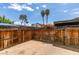 Private outdoor patio features a wooden fence, patterned tiling, and views of mature trees and blue skies at 516 Delfern Ln, Las Vegas, NV 89169