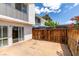 A fenced patio area just off the house boasts neutral tiles and sliding glass doors to the interior at 516 Delfern Ln, Las Vegas, NV 89169