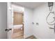 Bathroom with a washer and dryer hookup, next to the full bathtub and a modern toilet at 5335 Rod Ct # 103, Las Vegas, NV 89122