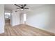 Bedroom with wood floors, featuring an ensuite bathroom with stylish vanity and mirror at 5335 Rod Ct # 103, Las Vegas, NV 89122