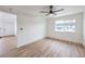 Bedroom with wood floors, featuring window for natural light and access to bathroom and closet at 5335 Rod Ct # 103, Las Vegas, NV 89122